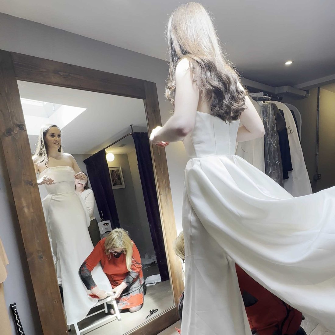 A bride seeing her dress in the mirror during a private fitting