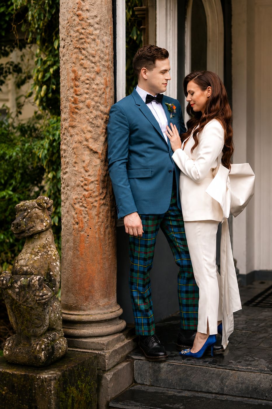 The couple beside a stone column