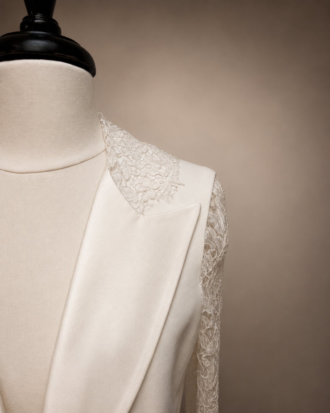 Lace and satin detail at the shoulder of a bridal jacket