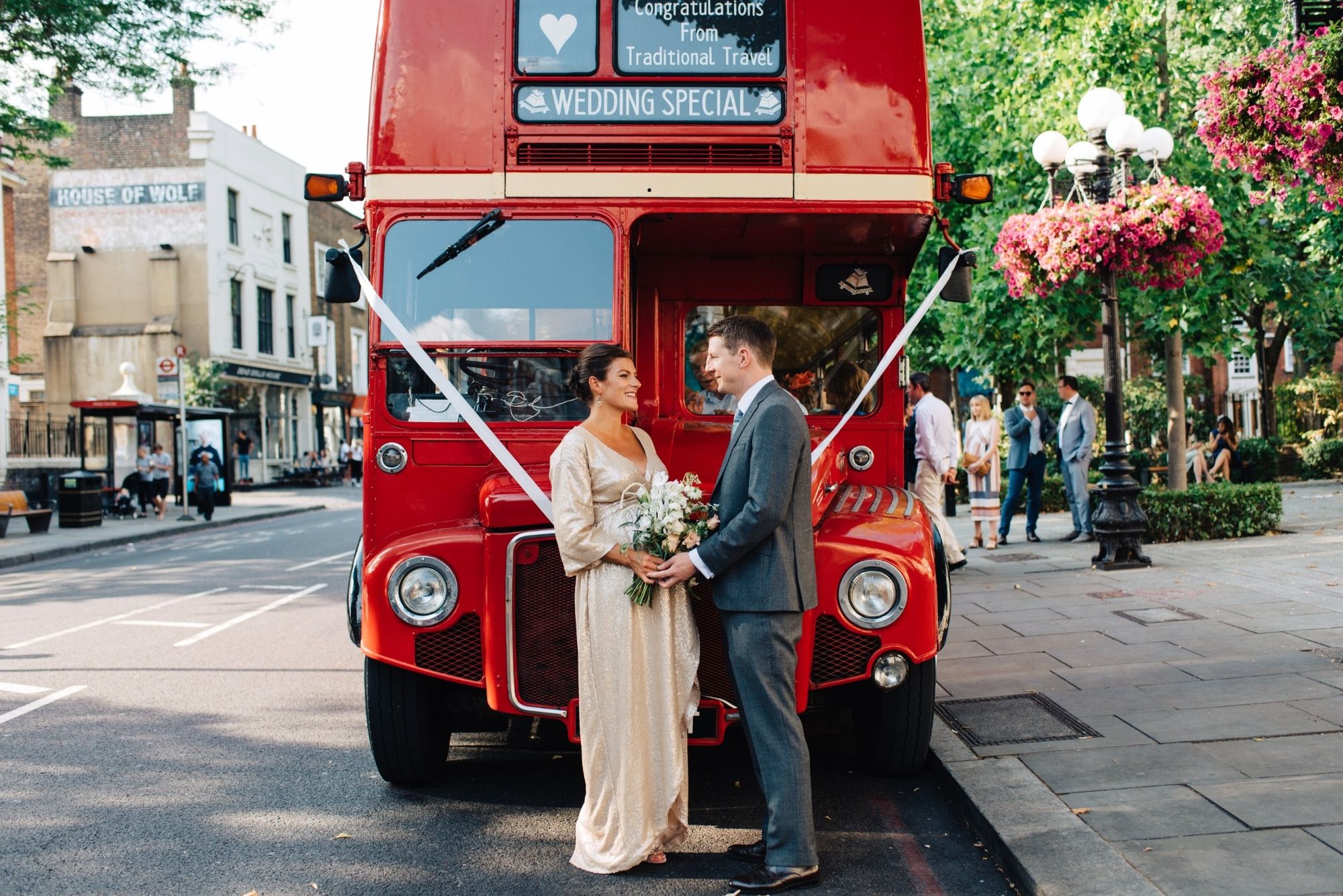 A bride passing a red London bus