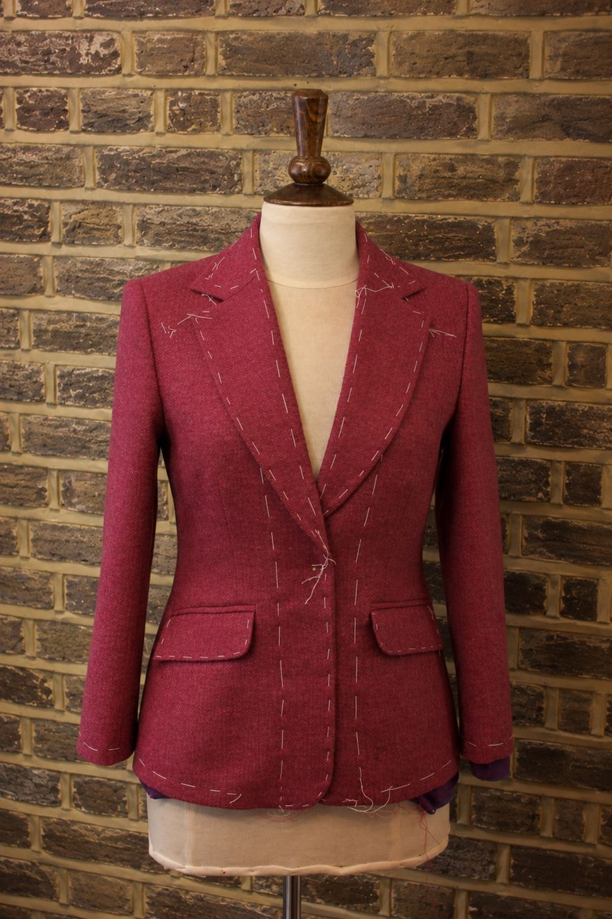 A raspberry blazer in the basted fitting stage