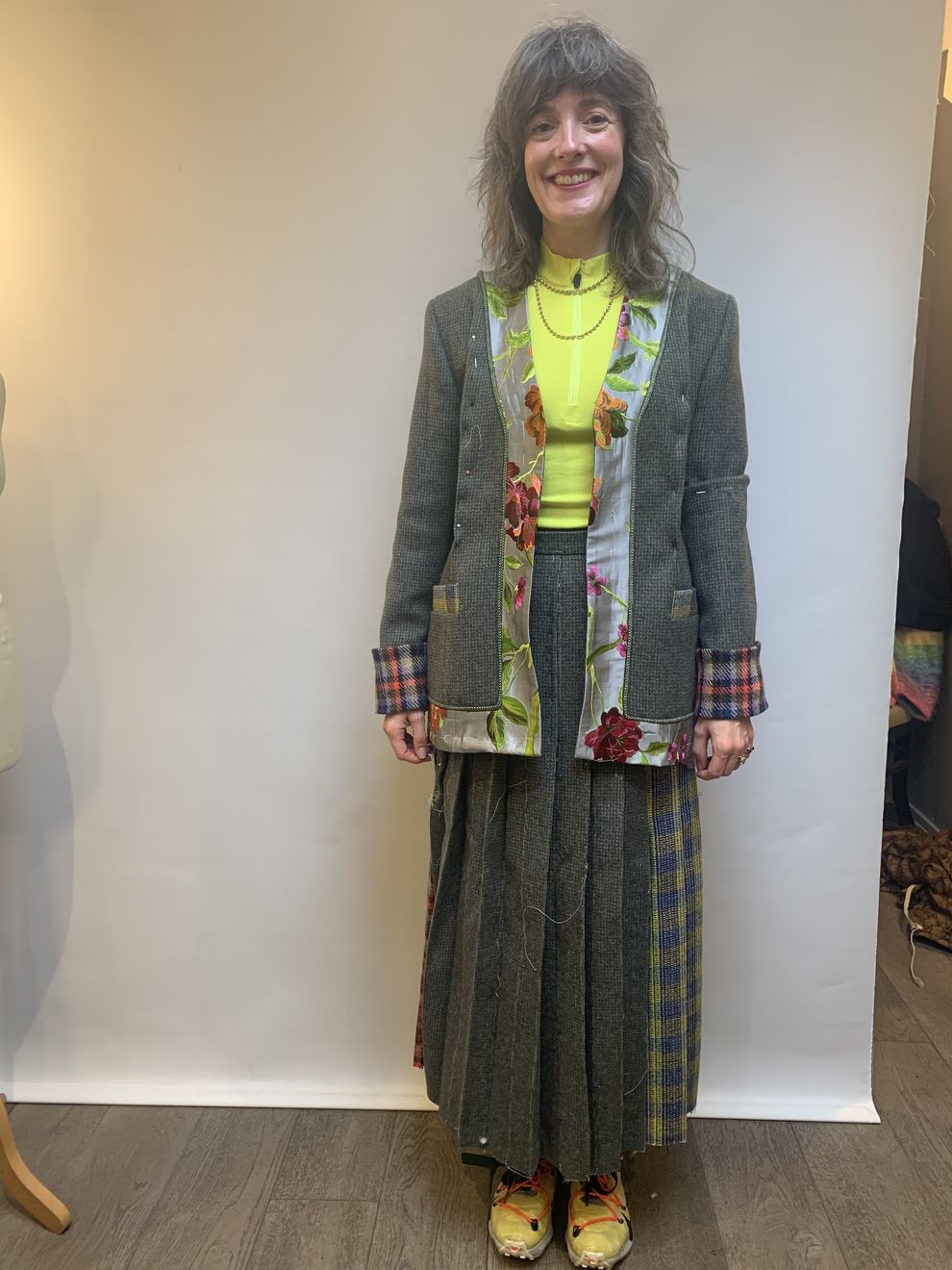 A client in her finished tweed jacket with a matching tartan skirt