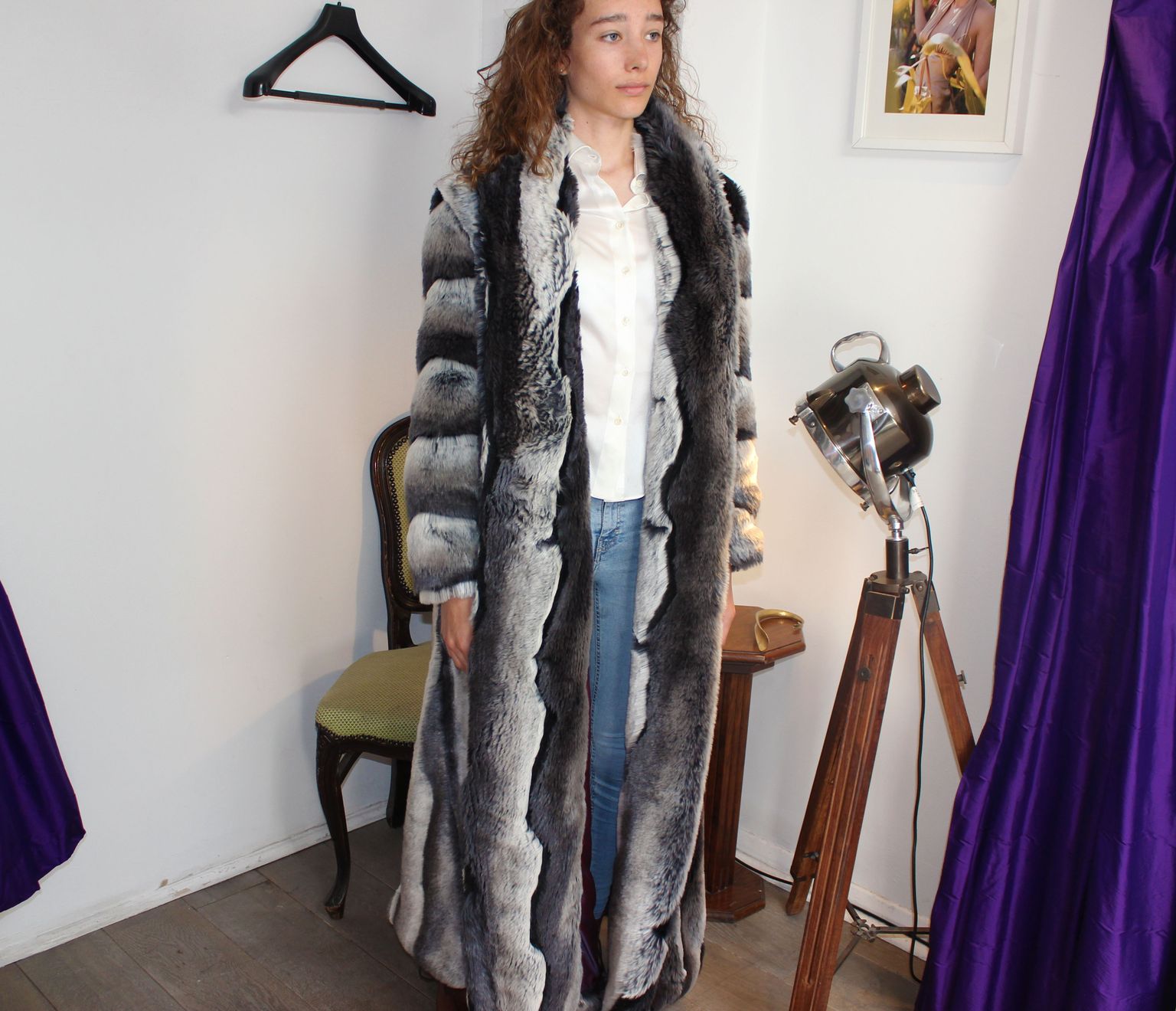 A dramatic fur-trimmed coat in the fitting room
