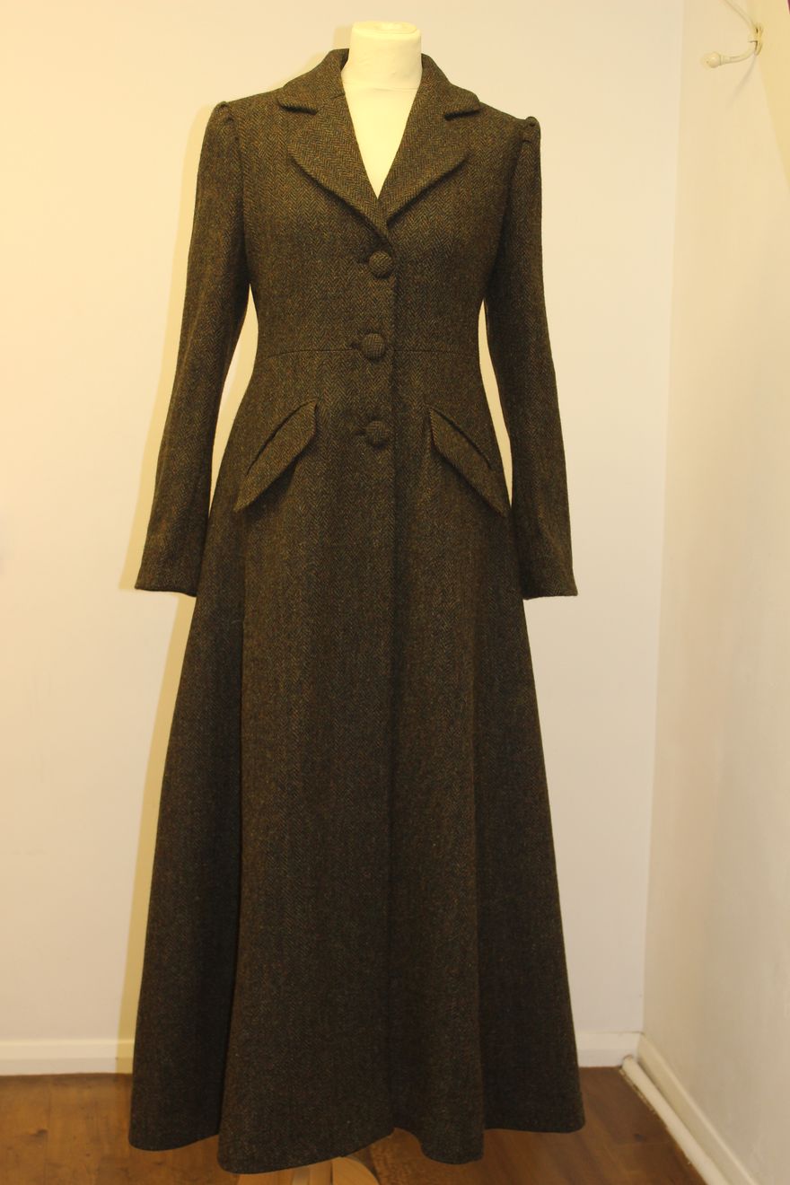 A brown fitted riding-style coat on the mannequin