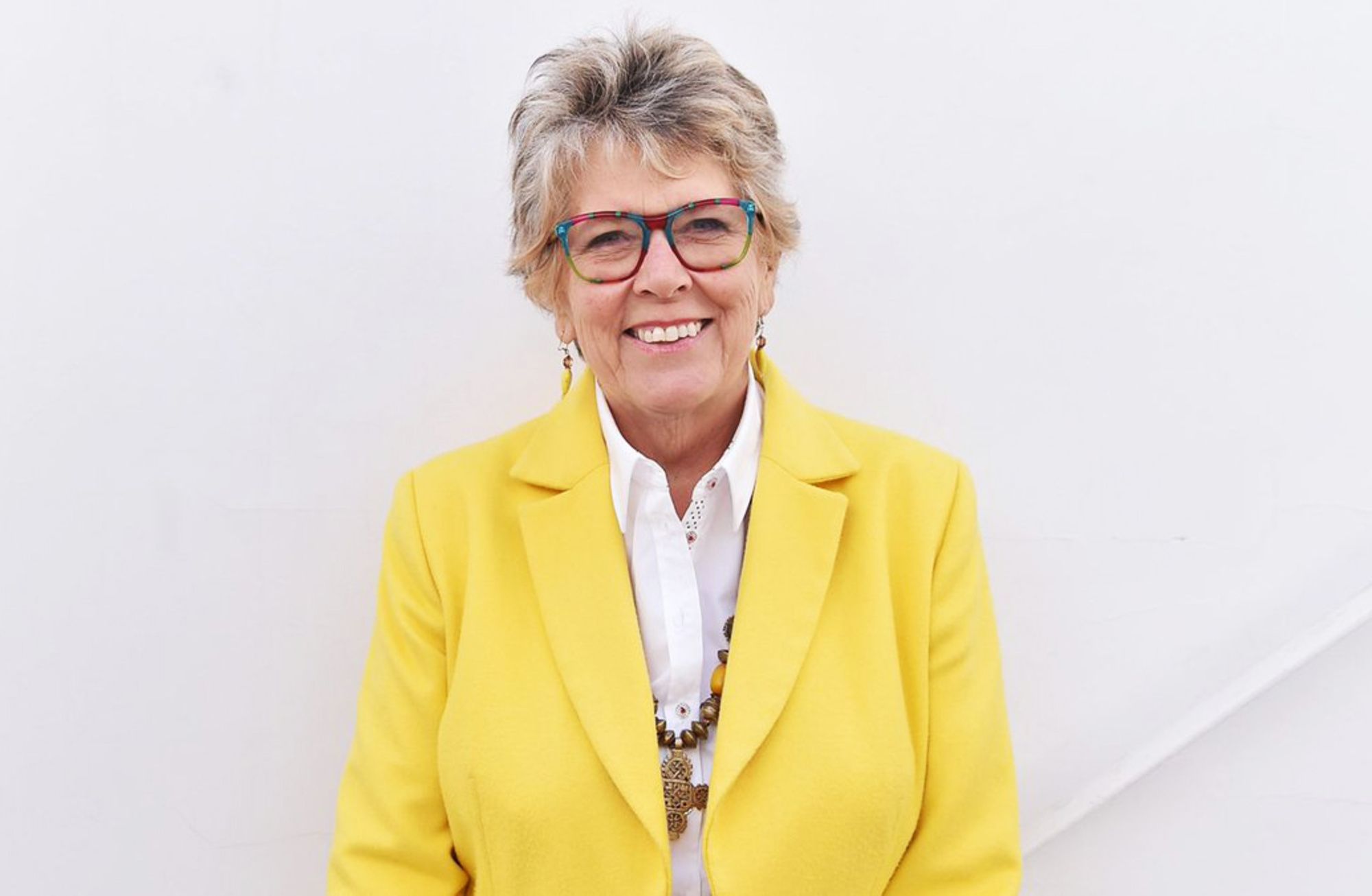 A sunshine yellow jacket worn with a smile