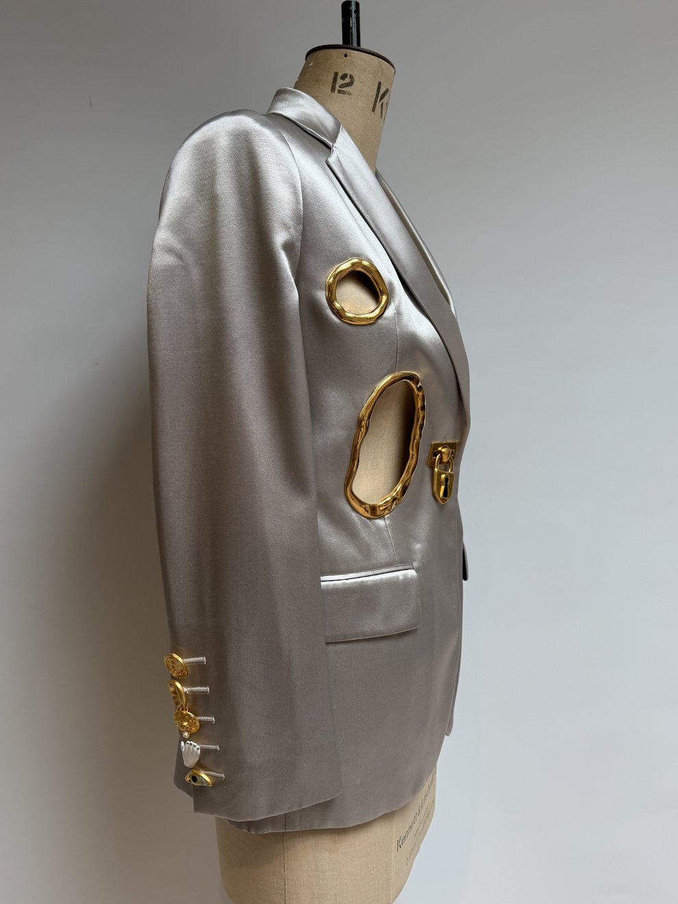 Side view showing the gold sleeve buttons of the reworked silver satin jacket