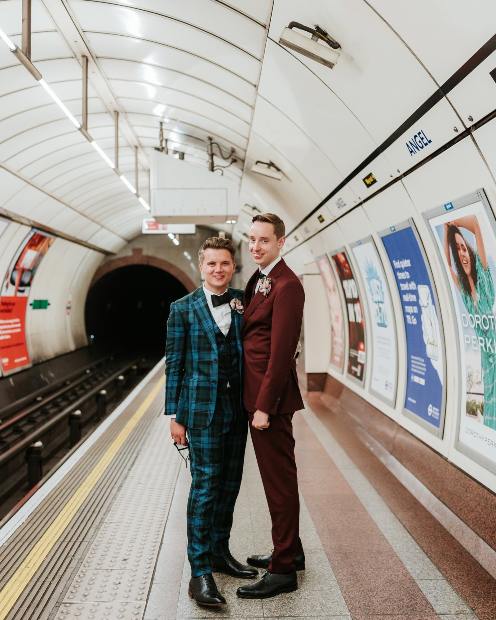 Grooms in a teal tartan three-piece and a burgundy suit on the Angel tube platform