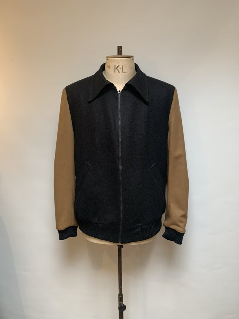 A black wool zip blouson with camel sleeves and ribbed cuffs