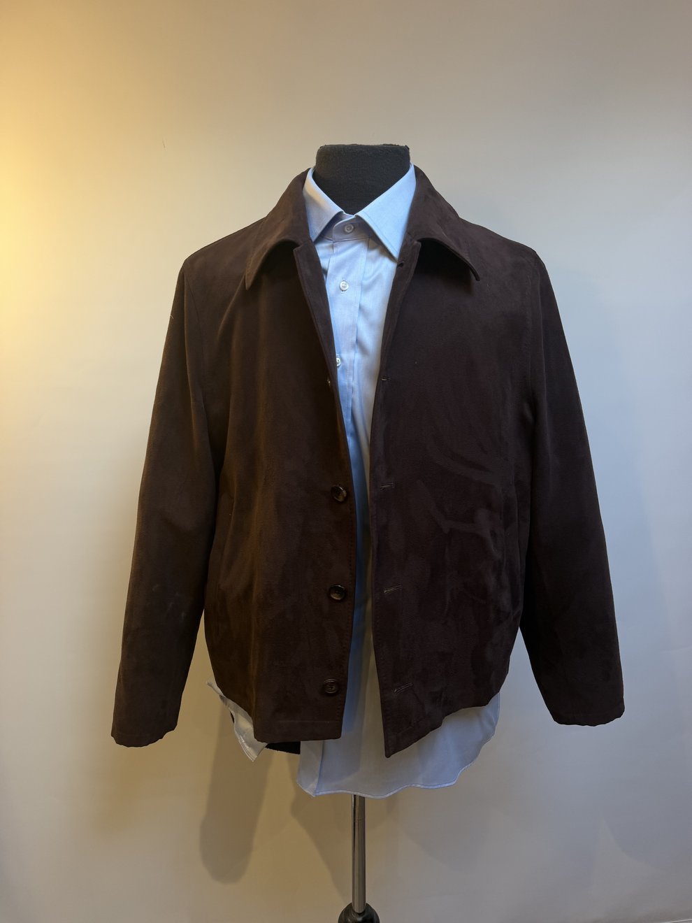 A chocolate brown suede blouson over a blue shirt