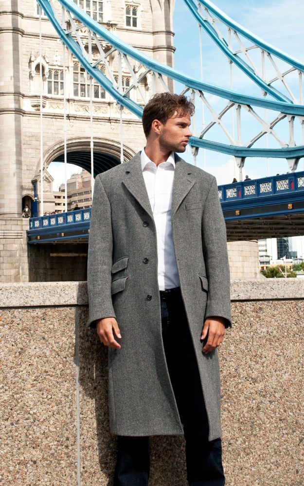 A grey wool overcoat worn open at Tower Bridge