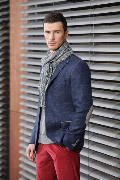 A navy windowpane jacket worn casually with a houndstooth scarf and red chinos