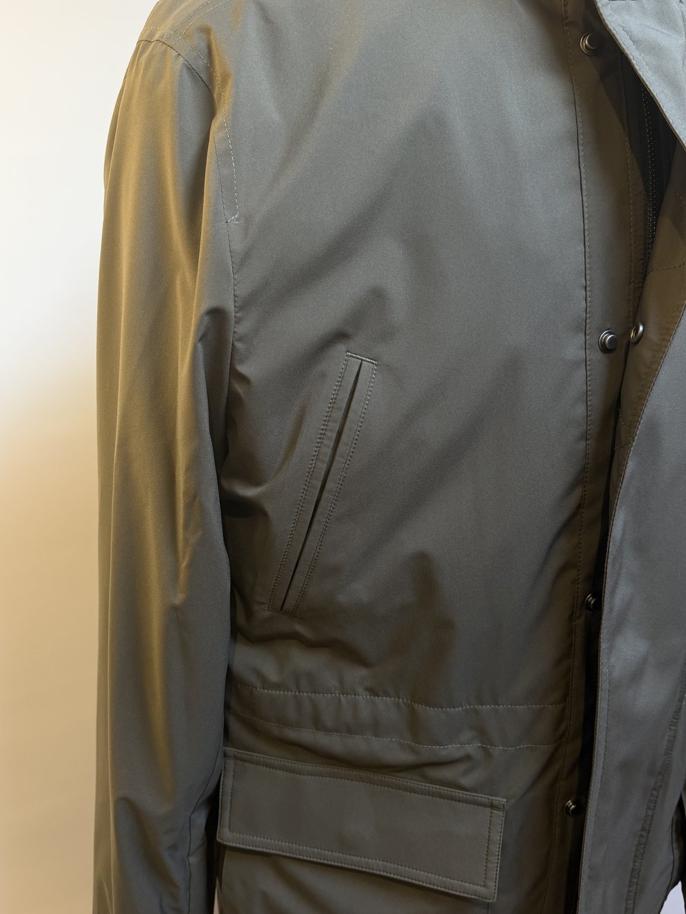 Sleeve and flap-pocket detail on a stone field jacket