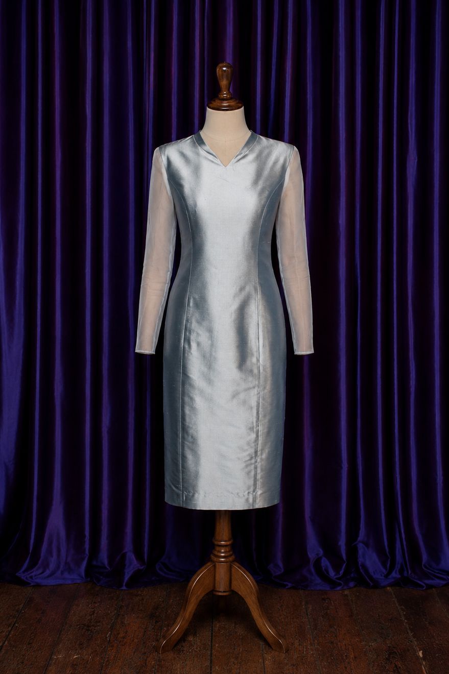 A silver evening dress on a mannequin in the studio
