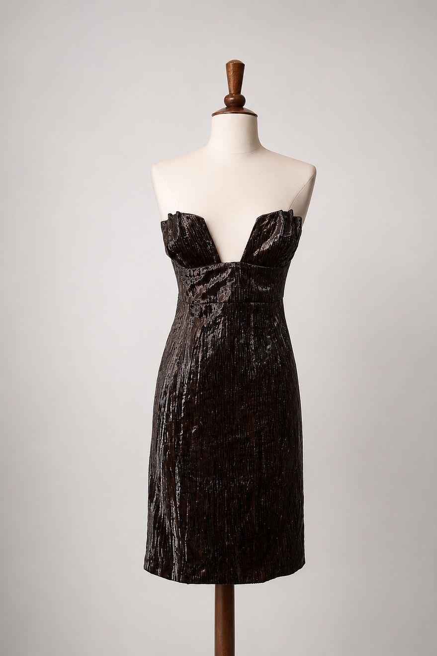 A black strapless gown fitted on the stand